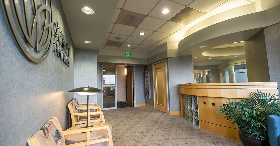 Reception desk under the Shroff Dental Arts logo